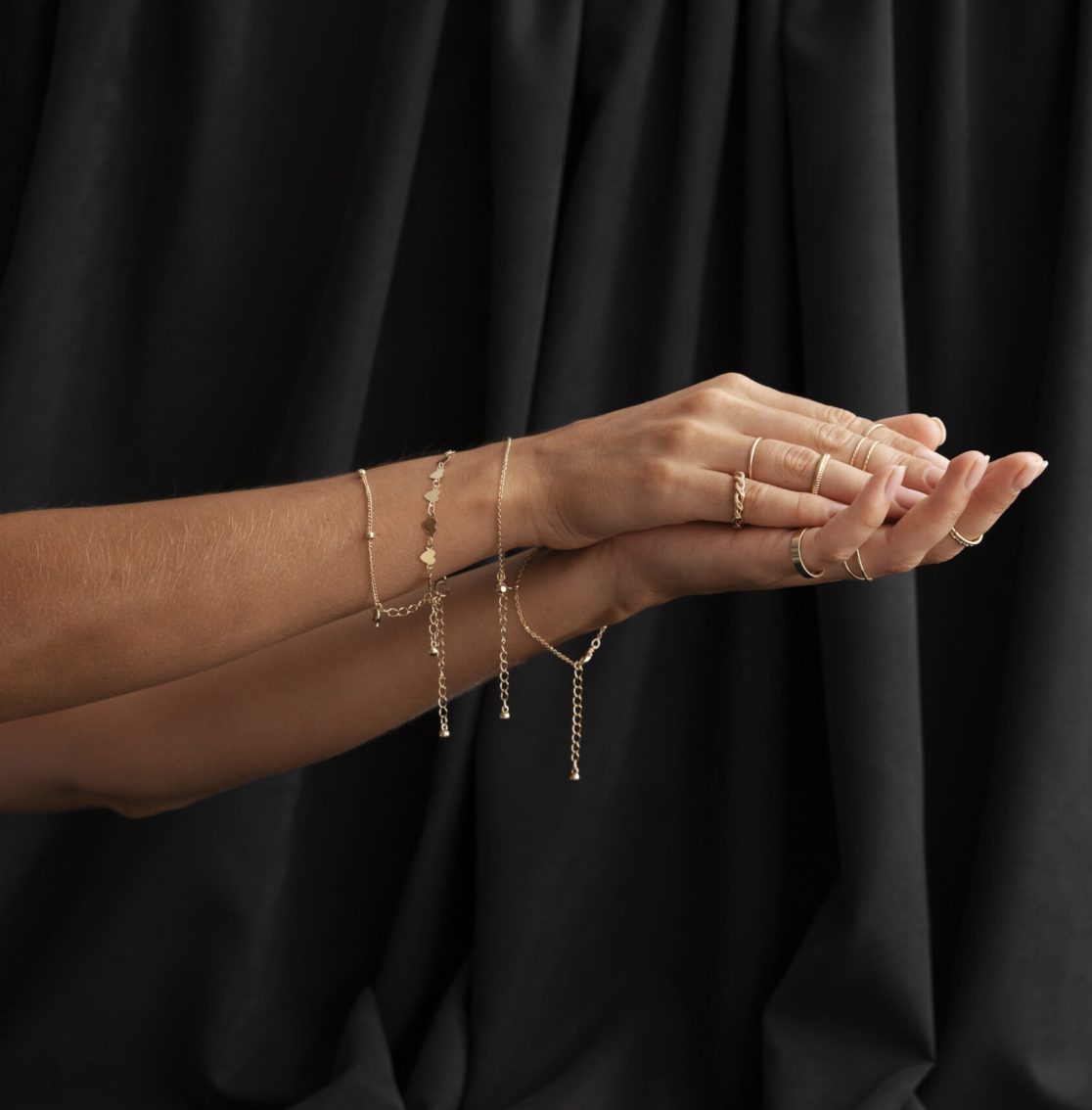 woman-s-arms-wearing-beautiful-jewelry